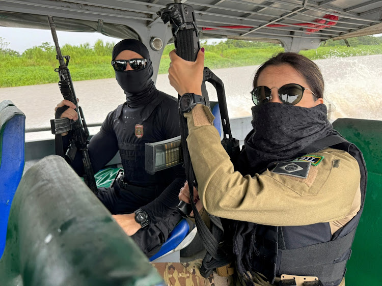 Federal Police officers hold weapons as they conduct a raid on a river during the Turquesa Operation, in Benjamin Constant Brazil November 30, 2023.