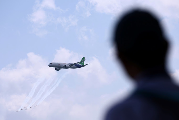 A Comac C919 flies past during an aerial flying display ahead of the Singapore Airshow at Changi Exhibition Centre in Singapore on Sunday. Picture: REUTERS/Edgar Su