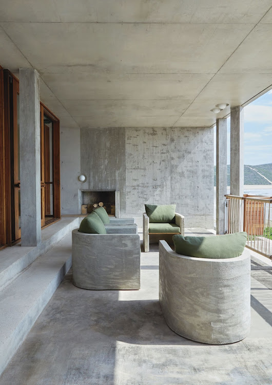 The sea-facing veranda at the front of the house is the ideal spot from which to enjoy panoramic beach views on wind-free days. Pienaar designed the weather-proof concrete outdoor chairs to be permanent fixtures. They were built by the concrete formwork contractor who worked on the house.