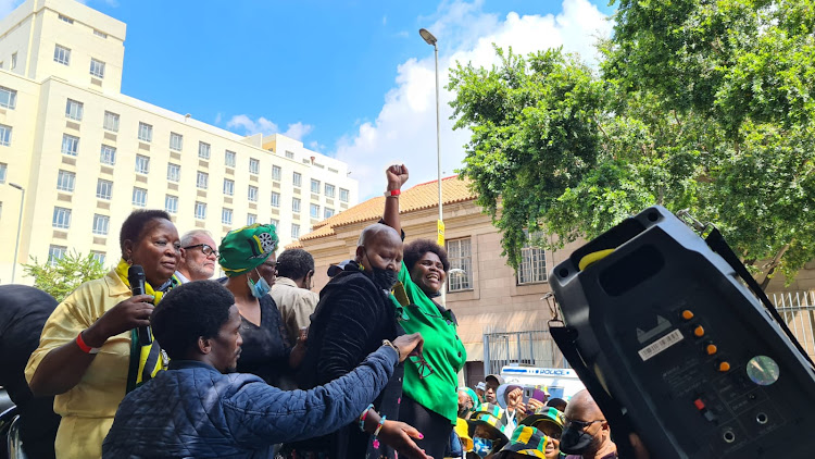 ANC leaders pile onto the back of a bakkie in Fox Street to address the crowd. Their speaker, on the right, was held in place on the head of one of Bathabile Dlamini's followers.