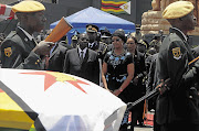 President Robert Mugabe and his wife, Grace, attend the funeral of the vice-president, John Nkomo, in Harare, Zimbabwe, yesterday Picture: REUTERS