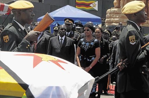 President Robert Mugabe and his wife, Grace, attend the funeral of the vice-president, John Nkomo, in Harare, Zimbabwe, yesterday Picture: REUTERS