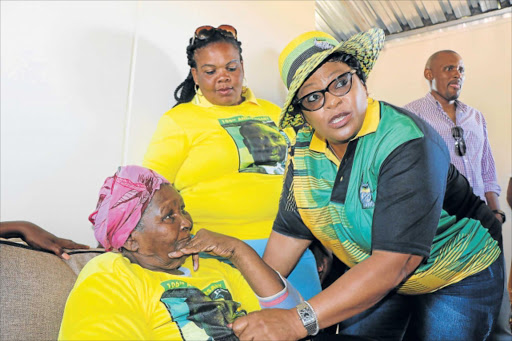 NEW BEGINNING: Water and Sanitation Minister Nomvula Mokonyane speaks to Evelyn Mavalati, 93, inside her new temporary house, which was donated to her by the ANC in Duncan Village yesterday Picture: BHONGO JACOB