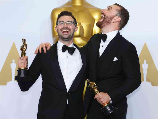 Jimmy Napes and Sam Smith (R), winners for Best Original Song for "Writing's on the Wall" from the film "Spectre", pose with their Oscars backstage during the 88th Academy Awards in Hollywood, California February 28, 2016. REUTERS/Mike Blake