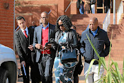 Media mogul Given Mkhari and his wife Ipeleng  exit the Randburg Magistrate's Court in Johannesburg after the pair laid assault charges against each other following an alleged  fight at the weekend.