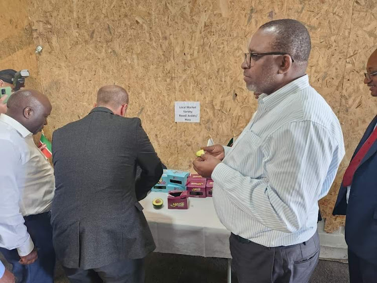 Agriculture CS Mithika Linturi eating a piece of avocado in Israel on Wednesday.