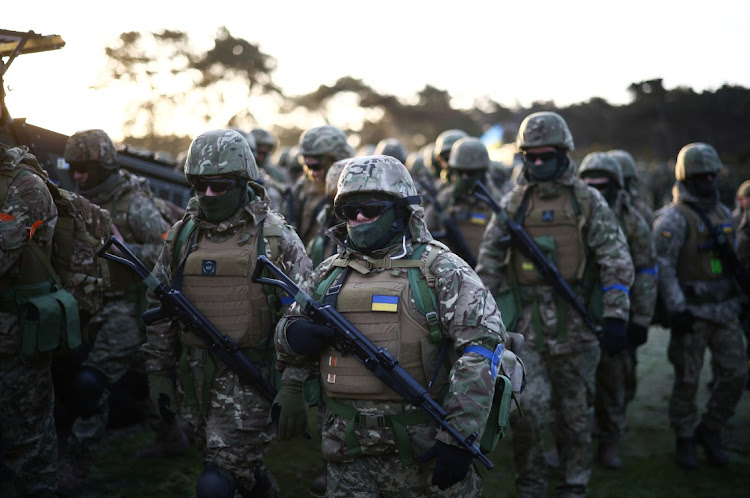 Ukrainian military recruits move after taking part in prayers, blessings and a one minute silence alongside British and Canadian troops, to mark the first anniversary of the Russian invasion of Ukraine, at a military base in the south east of Britain on February 24 2023. Picture: REUTERS/Henry Nicholls