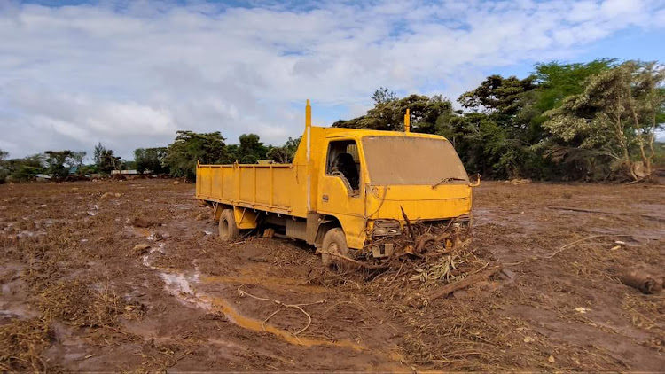 A lorry stuck on a fallen tree after a river broke banks and wrecked havoc in Kamuchiri Village in Mai Mahiu, Nakuru County on April 29, 2024.