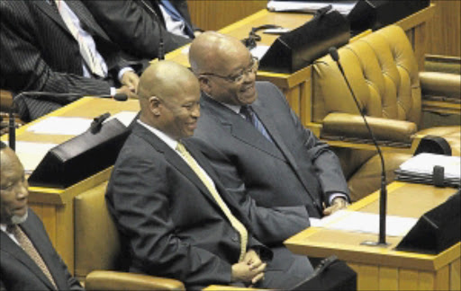 ALL SMILES: Judge Mogoeng Mogoeng shares a joke with President Jacob Zuma in Parliament. Circa November 2011 PHOTO: KEVIN SUTHERLAND