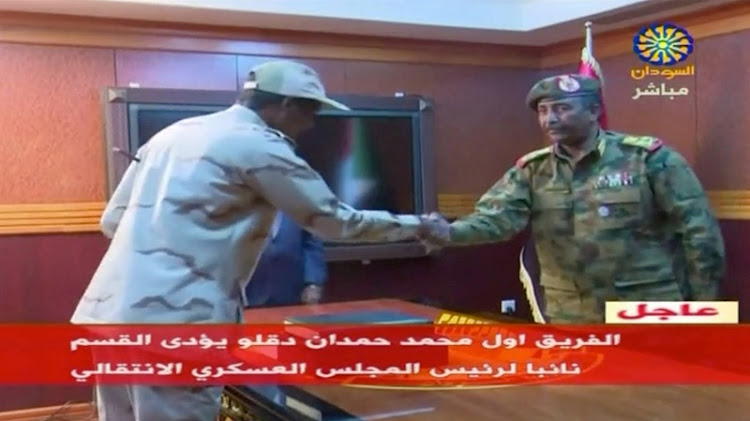Sudan's General Abdelfattah Mohamed Hamdan Dagalo is sworn in as deputy head of Sudan's Transitional Military Council, standing before the head of the council, Lieutenant General Abdel Fattah Al-Burhan Abdelrahman (R) in Khartoum.