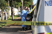 Police cordoned off the Durban house where a delivery of flowers and a card exploded. A member of the Kahn family, still in a hospital gown after helping the victims, was driving along the road when the bomb went off. Photo: Supplied