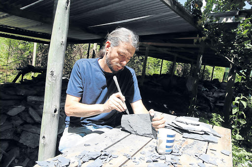 FOSSIL FIND: Renowned paleontologist Rob Gess works on the shale rock salvaged near Grahamstown from which he has collected 30 specimens of more or less complete juvenile coelacanths Picture: FILE