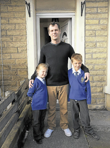 Justin Tutt with Leigh and Seth outside their home in Burnley, Lancashire Picture: RON LAMB/ CAVENDISH PICTURE