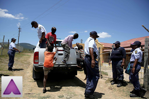 SAFE AND SOUND: A police search for three missing Keiskammahoek boys was called off at noon yesterday when they were found sunbathing at a nearby river. A friend of the boys (standing in bakkie) assisted the police with the search Picture: MARK ANDREWS