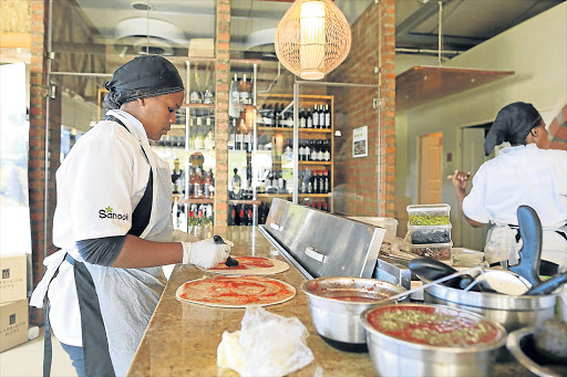 PIZZA PARADISE: Chefs at Sanook Eatery make pizza at their restaurant at Beacon Bay Crossing. Picture: STEPHANIE LLOYD