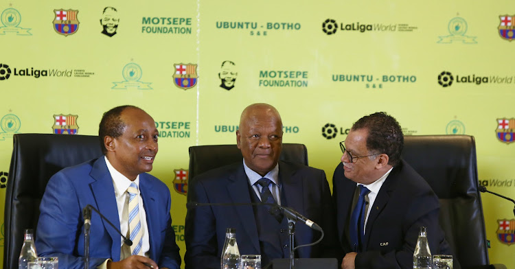 Mamelodi Sundowns president Patrice Motsepe (L), Energy Minister Jeff Radebe (C) and SA Football Association president Danny Jordaan (R) at a press conference at Sandton Convention Centre, Johannesburg, on Thursday May 10 2013.