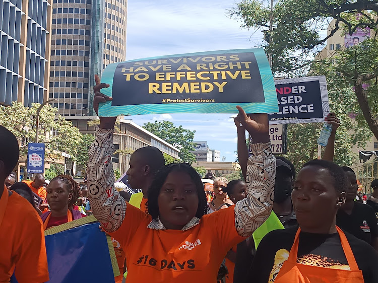 A protester holds up a sign calling for survivors of sexual violence to be given an effective remedy after the violation of their rights in Nairobi on Friday, December 9, 2022.