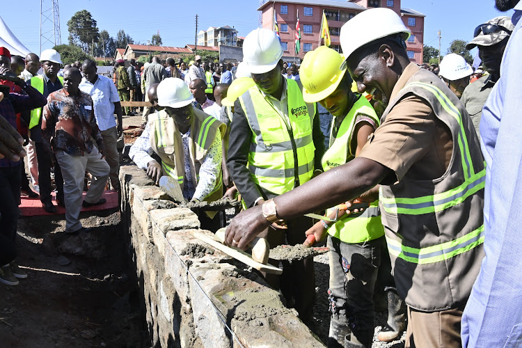 President William Ruto joins construction workers at the site of Nyeri Blue Valley Affordable Housing in Nyeri county on February 16, 2024