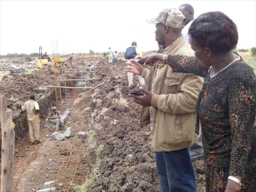 A member of Maasai Village Women’s Self-Help Group points at her plot , which she says has been grabbed /JOHN KAMAU