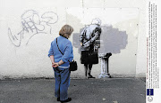 LIFE IMITATES ART: Banksy's new work 'Art Buff' in Folkestone, Kent, in Britain. The local council has covered the graffiti artwork with plexiglass for protection and a security guard is stationed beside it