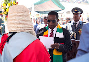 Zimbabwe President Emmerson Mnangagwa takes an oath of office during  his inauguration at the National Sports Stadium in Harare, Zimbabwe September 4, 2023. 