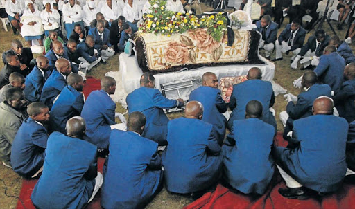 PAYING RESPECT: Twelve Apostolic Church members surround the coffin carrying the body of Sikhosiphi Bazooka Radebe, the Amadiba Crisis Committee chairman who was buried in Mdayte village, in Xolobeni near Mbizana, on Saturday. Picture: LULAMILE FENI