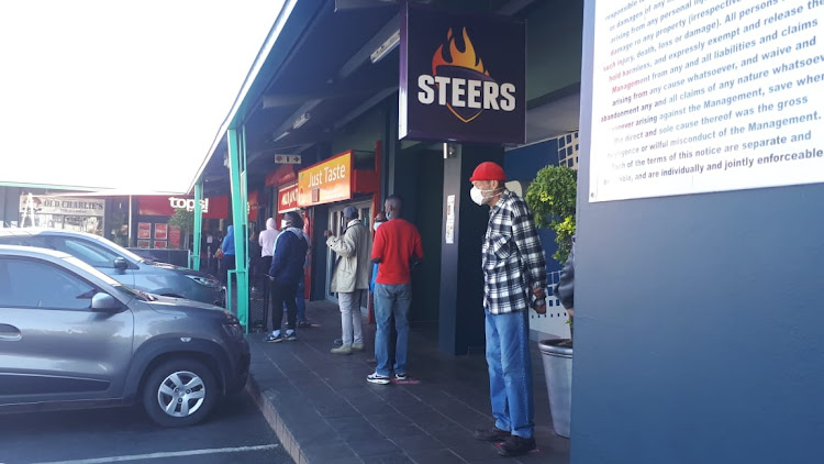 A queue to buy drinks in a Johannesburg street.