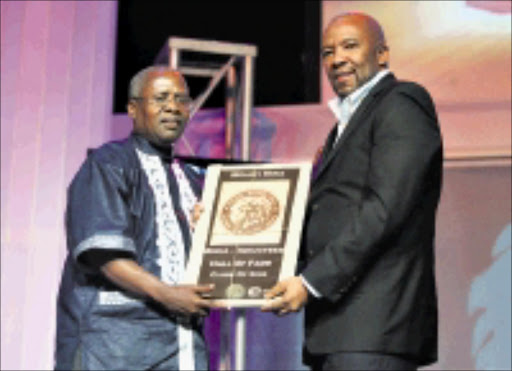 PROUD: Sowetan sports editor Molefi Mika receives a certificate confirming his induction into the South African Sport Hall of Fame from Gab Mampone, group CEO of SABC. 25/02/09. Pic. Veli Nhlapo. © Sowetan.
