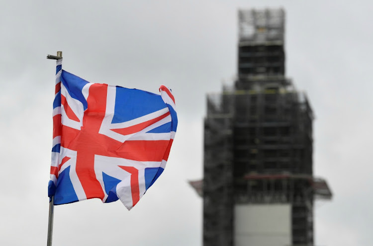 A Union Jack flag flutters as Big Ben clock tower is seen behind at the Houses of Parliament in London, Britain. Picture: TOBY MELVILLE/REUTERS