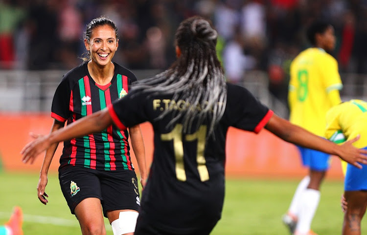 Ibtissam Jraidi (left) of AS FAR celebrates with teammate Fatima Tagnaout after scoring her hat trick in the 2022 Caf Women’s Champions League final against Mamelodi Sundowns at Stade Prince Moulay Abdallah in Rabat, Morocco, on November 13 2022.