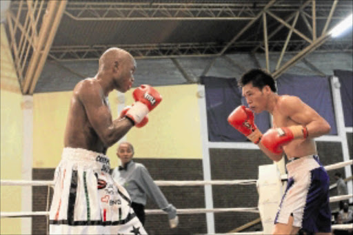 DIFFICULT FIGHT: SA junior bantamweight champion Miniyakhe Sityatha, left, goes forward during his non-title bout against Filipino boxer Marjohn Yap in East London on Saturday. Sityatha won by unanimous decision. Picture: SINO MAJANGAZA