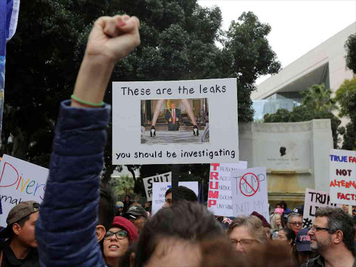 A protester holds a sign referencing alleged Russia leaks as people denounce policies of President Donald Trump on Presidents Day at the Not My President's Day Rally in Los Angeles, California February 20, 2017. /REUTERS