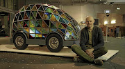 Dominic Wilcox with his stained-glass driverless car.