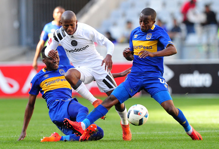 Orlando Pirates winger Luvuyo Memela is challenged by Cape Town City's Mpho Matsi (L) and Thabo Nodada (R) during the Absa Premiership match at Cape Town Stadium on April 28 2018. Memela picked an injury in this match and has played ever since.