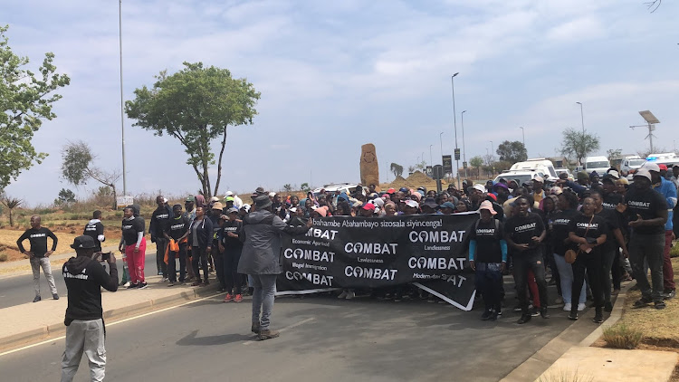 Combat members march towards Cosmos Business Park to hand over a memorandum of demands.