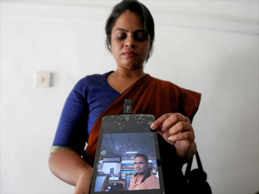 Namalee Makalandawa, a sister of Sampath, who is one of the crew members of an oil tanker hijacked by Somali pirates, shows a picture of him after a meeting with Sri Lankan Foreign Ministry officials, in Colombo, Sri Lanka, March 16, 2017. /REUTERS