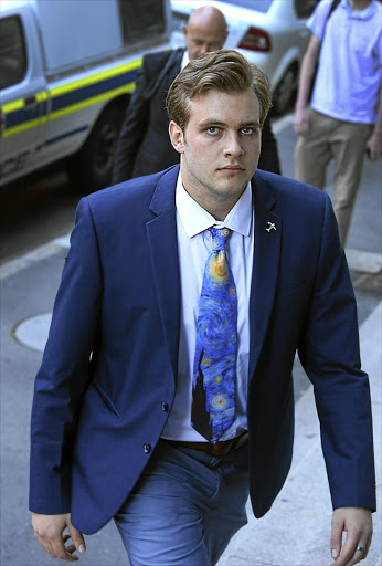 Henri van Breda arrives at the Cape Town High Court with a new haircut on the day in which a photo of a hand holding a strand of hair was said by the defence to be too long to be Henri's.