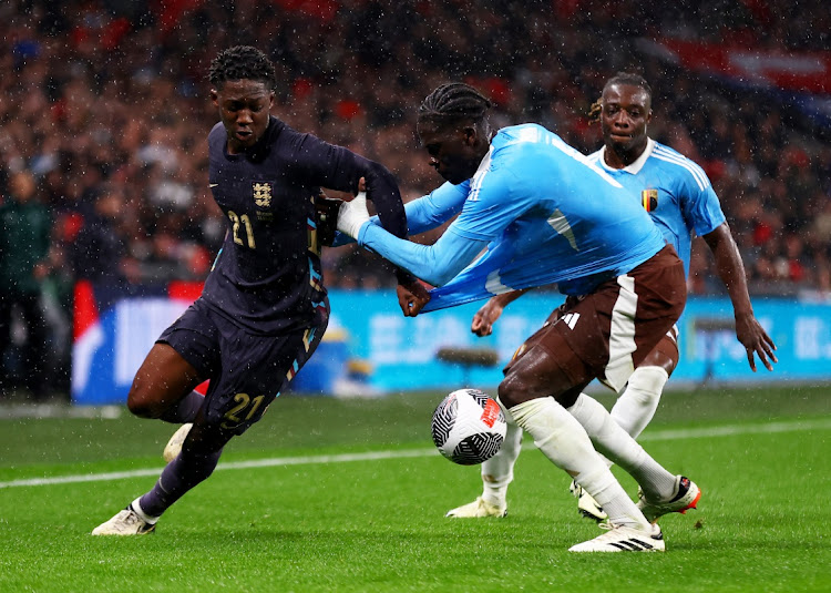 England's Kobbie Mainoo in action with Belgium's Amadou Onana and Jeremy Doku in their international friendly at Wembley Stadium, London on March 26, 2024