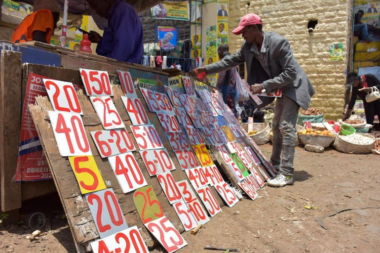 A business vendor arranges price tags at his stall at Wakulima market on April 7, 2022.