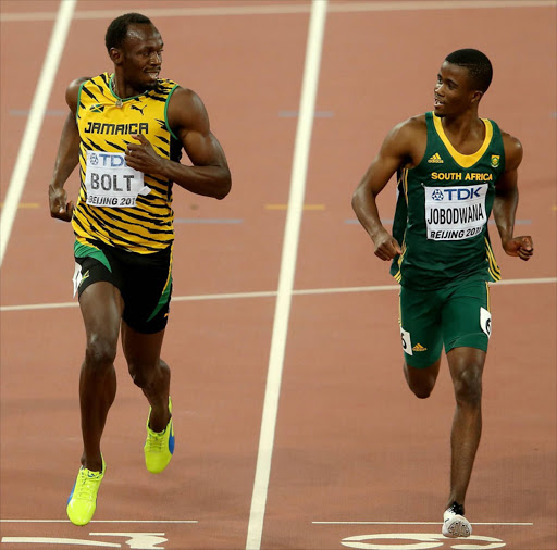 Usain Bolt of Jamaica and Anaso Jobodwana of South Africa compete in the Men's 200 metres semi-final during day five of the 15th IAAF World Athletics Championships Beijing. Getty Images