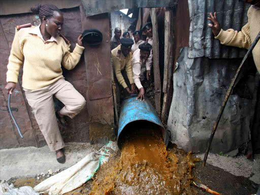 Chiefs destroy illicit liquor at Motherland slum, Eastleigh, on July 14, where they found 2,000 litres / COLLINS KWEYU