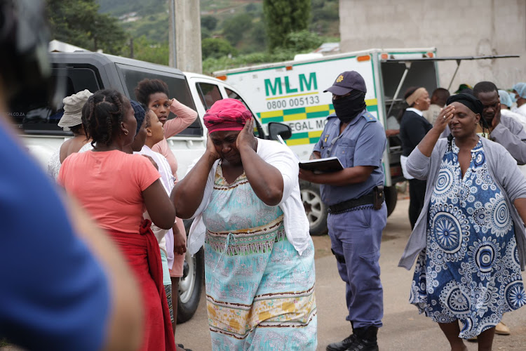 There were emotional scenes as family members of nine suspected criminals who died in a shoot-out with police identified bodies.
