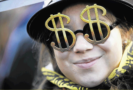 A protester wearing dollar-sign glasses. File photo
