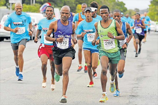 HAT-TRICK RUNNER: Defending champion Luthando Hejana, front left, from Mdantsane, shows his liking for the annual 9.8km Family Challenge race when he triumphs for the third time in a row in East London on Saturday Picture: ALAN EASON