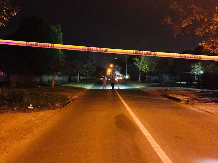 Police forensic officers search for clues at the scene where police raided the hideout of suspected cash-in-transit robbers.