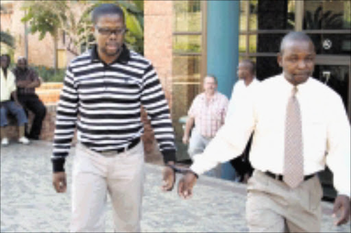 CAUGHT: Mngomezulu Fannie Manzini, left, and Khawulile Sibeko were handcuffed in full view of their colleagues when they were arrested last week. Pic. Riot Hlatshwayo. 15/08/08. © Sowetan.