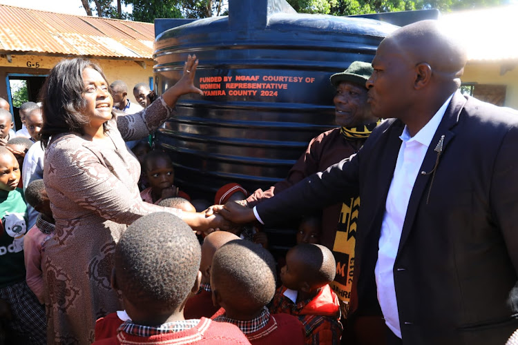 Nyamira County Women Rep Jerusha Momanyi hands over a water tank to Omorare PAG Primary school administration in North Mugirango on Thursday March 28, 2024.