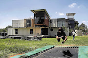 Children at play at the new eco-friendly New Jerusalem Children's Home, in Midrand, northern Johannesburg. The home is built of shipping containers, uses solar panels and recycles water for its garden.