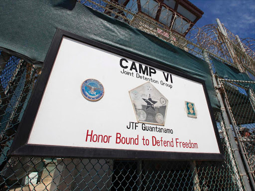 A guard opens the gate at the entrance to Camp VI, a prison used to house detainees at the US Naval Base at Guantanamo Bay, Cuba, March 5, 2013. /REUTERS