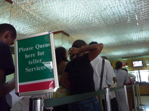 People queue at a banking hall in Mombasa.Photo/FILE